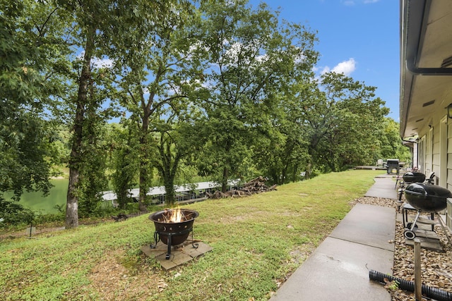 view of yard featuring a patio area and an outdoor fire pit