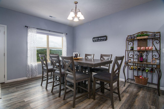 dining area featuring an inviting chandelier and dark hardwood / wood-style flooring