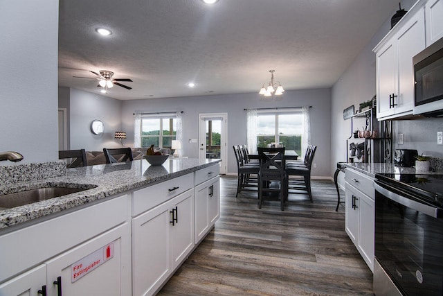 kitchen featuring dark wood-type flooring, appliances with stainless steel finishes, sink, and white cabinetry