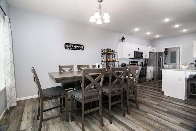 dining room with a chandelier and dark hardwood / wood-style flooring