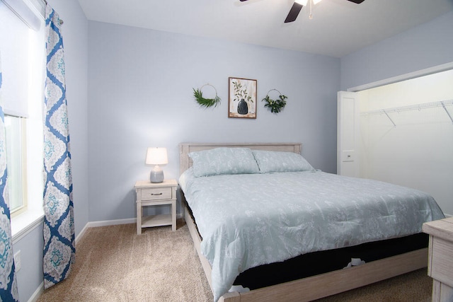 bedroom with ceiling fan, carpet floors, and a closet