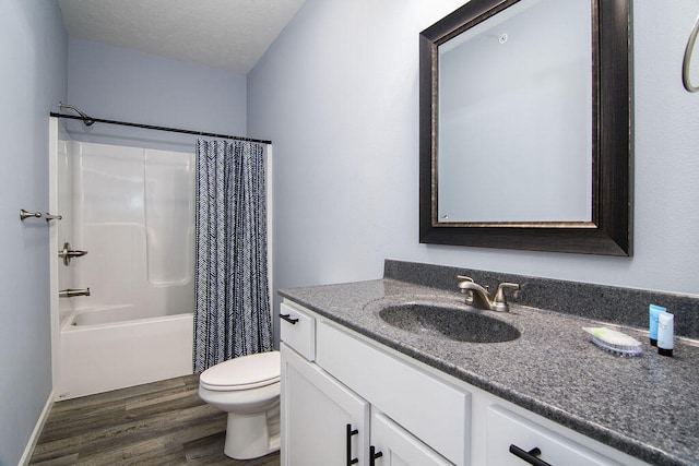 full bathroom with vanity, wood-type flooring, shower / bath combo, toilet, and a textured ceiling