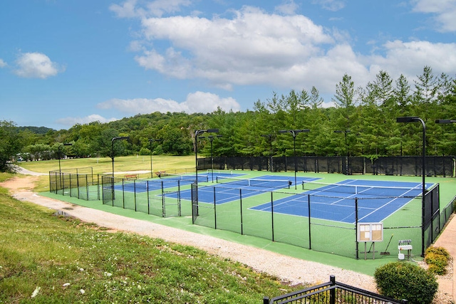 view of sport court featuring a yard