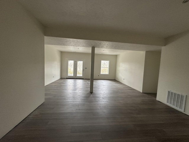 empty room featuring dark hardwood / wood-style floors and a textured ceiling