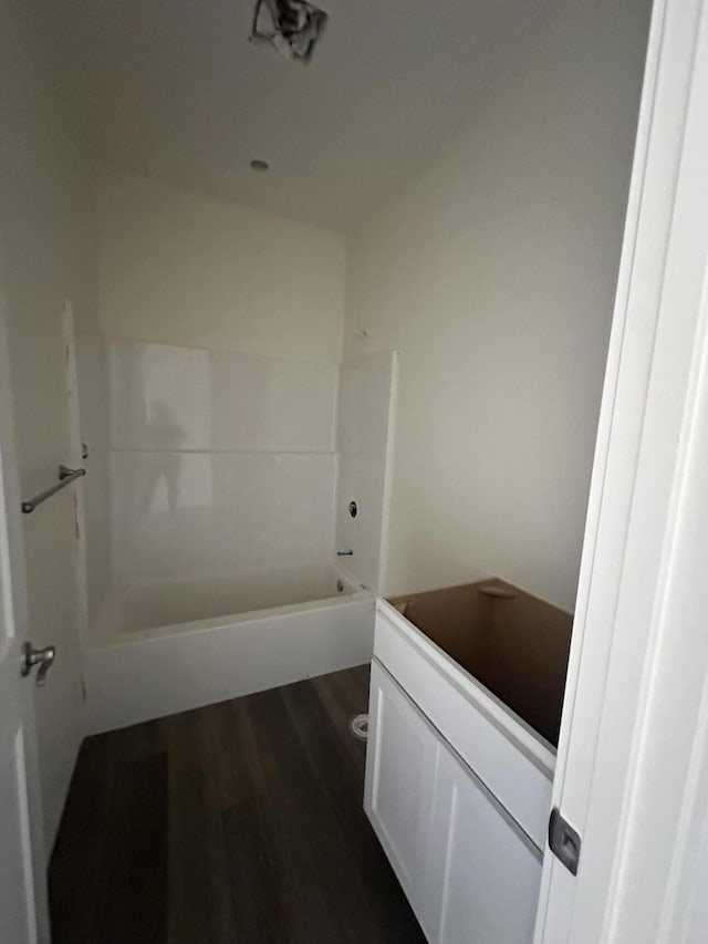 full bathroom with vanity, hardwood / wood-style floors, toilet, and washtub / shower combination