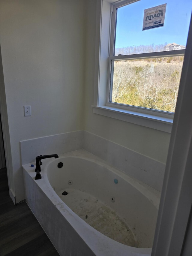 bathroom featuring a tub with jets