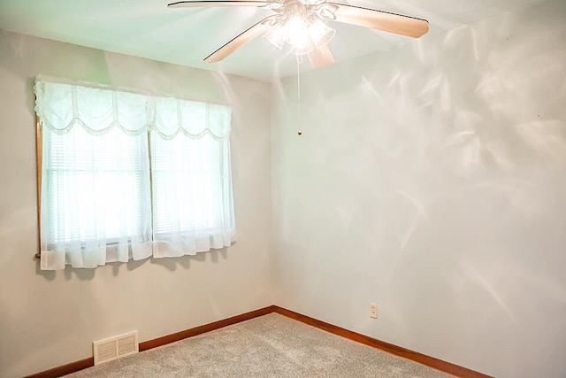 unfurnished room featuring ceiling fan and carpet