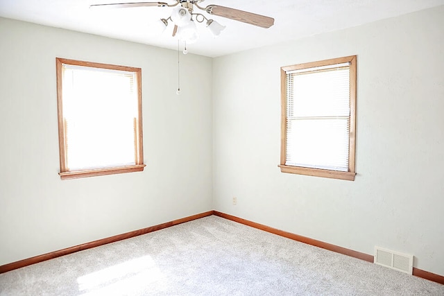 spare room with carpet flooring and ceiling fan