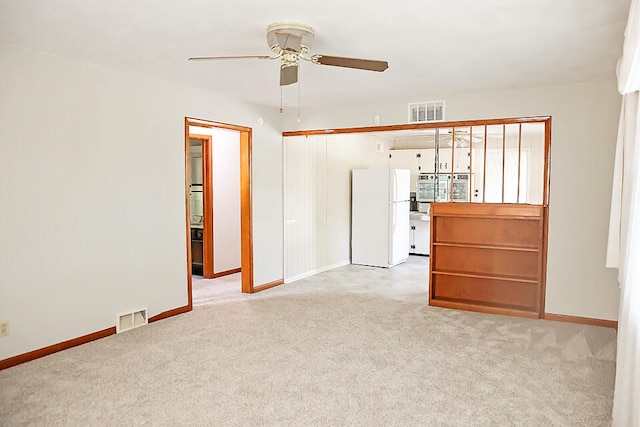 unfurnished room with ceiling fan and light colored carpet