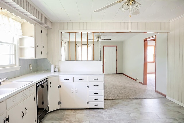 kitchen featuring ceiling fan, light colored carpet, sink, dishwasher, and white cabinetry