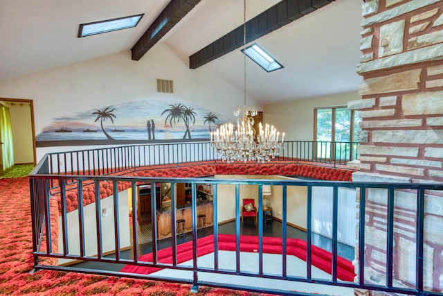 interior details with a notable chandelier, beamed ceiling, a skylight, and carpet flooring