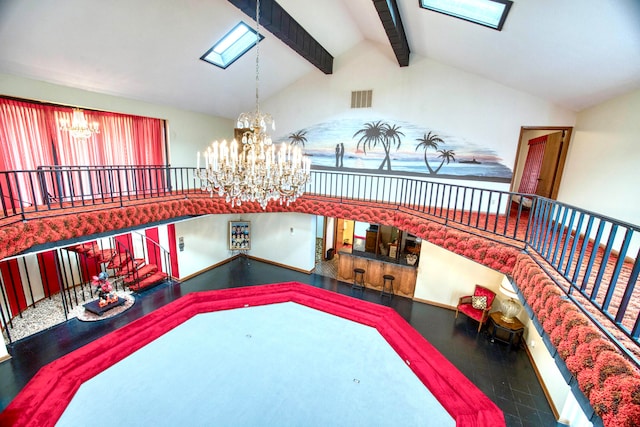 living room featuring a notable chandelier, hardwood / wood-style floors, and lofted ceiling with skylight