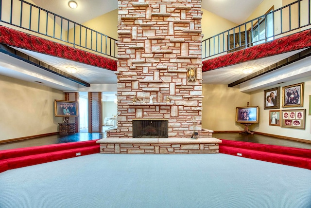 unfurnished living room with a fireplace, carpet flooring, and high vaulted ceiling