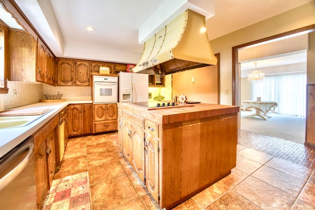 kitchen with white appliances, a kitchen island, range hood, wood counters, and backsplash