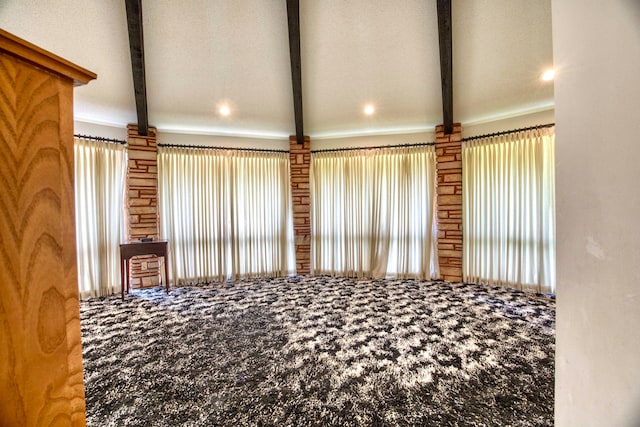 room details with beam ceiling, carpet floors, and a textured ceiling