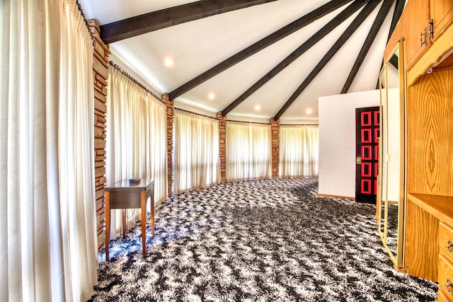 hallway featuring plenty of natural light, carpet flooring, and vaulted ceiling with beams