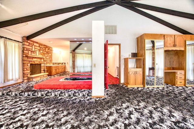 living room with high vaulted ceiling, beam ceiling, carpet, and a healthy amount of sunlight