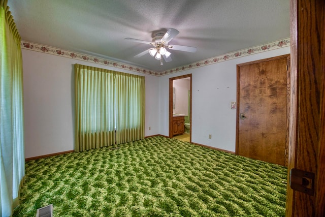 unfurnished room featuring carpet flooring, ceiling fan, and a textured ceiling