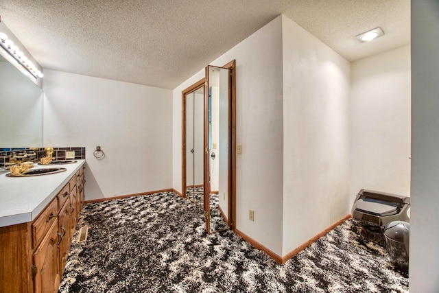 bathroom with vanity and a textured ceiling