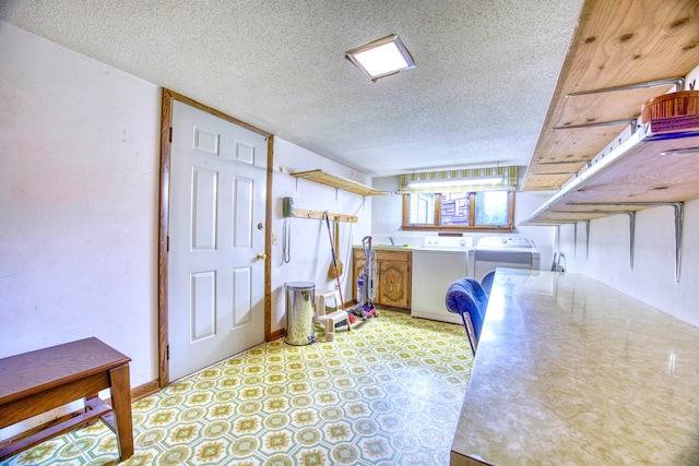 kitchen featuring washer and dryer and a textured ceiling