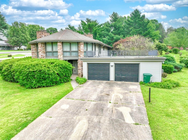 view of front facade with a front yard, a balcony, and a garage