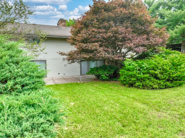 view of home's exterior featuring a yard and a patio