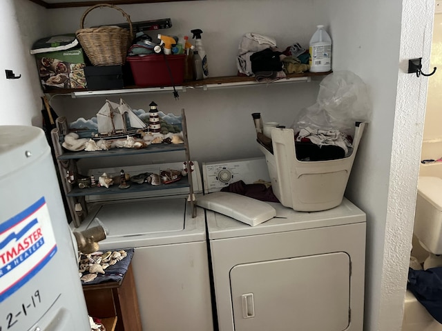 laundry area featuring water heater, laundry area, and separate washer and dryer