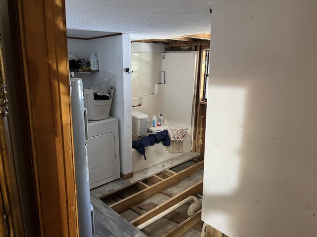 laundry room with a textured ceiling and washer / clothes dryer