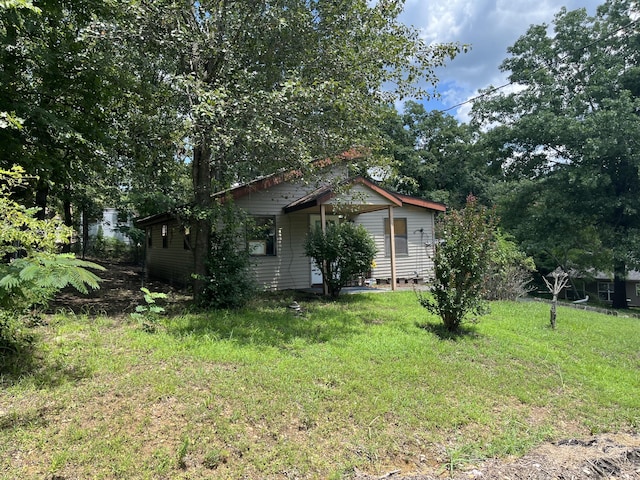 view of property exterior with a yard