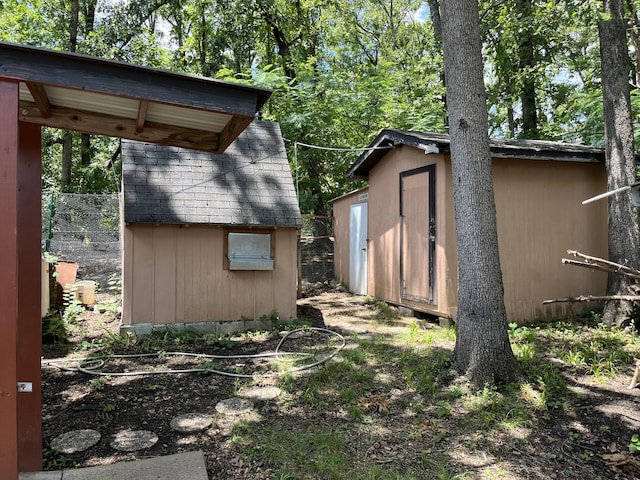 view of shed with fence