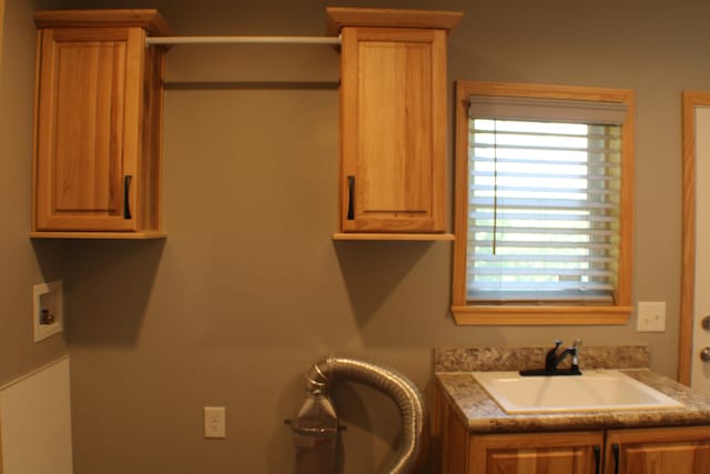 laundry area featuring washer hookup, cabinets, and sink