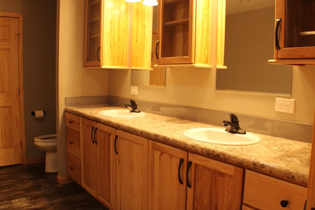 bathroom with hardwood / wood-style floors, vanity, and toilet