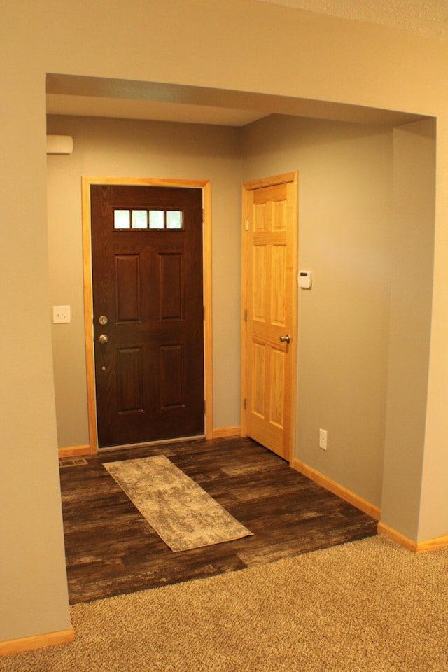 foyer with dark hardwood / wood-style floors