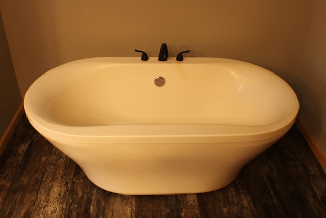 interior details with hardwood / wood-style flooring and a bathing tub