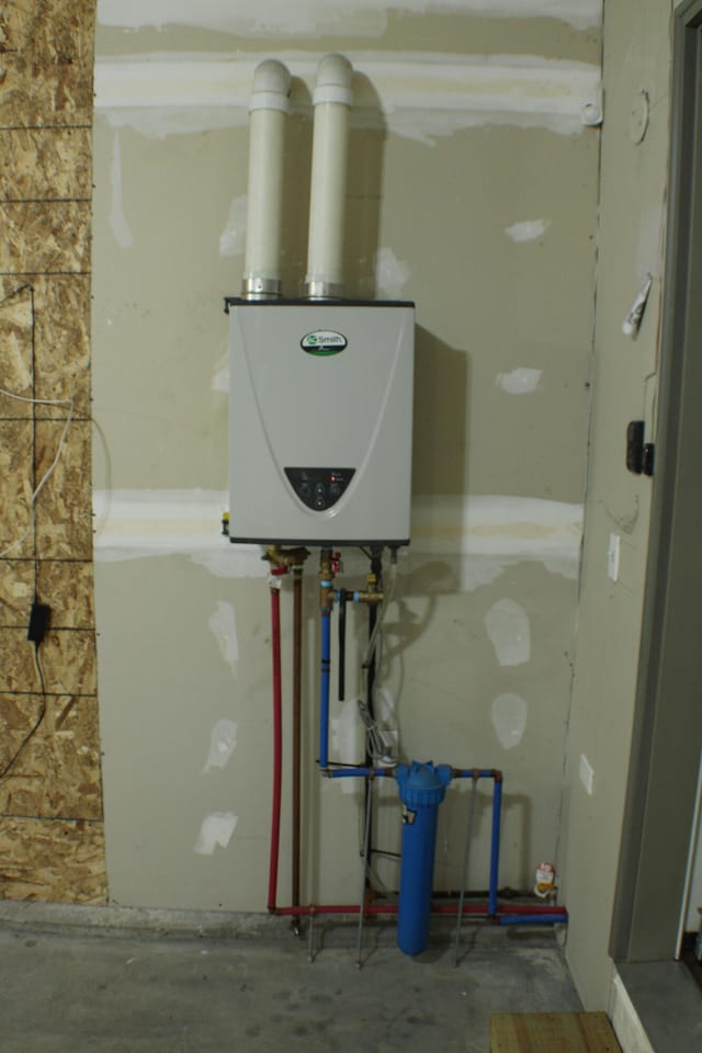 utility room featuring water heater