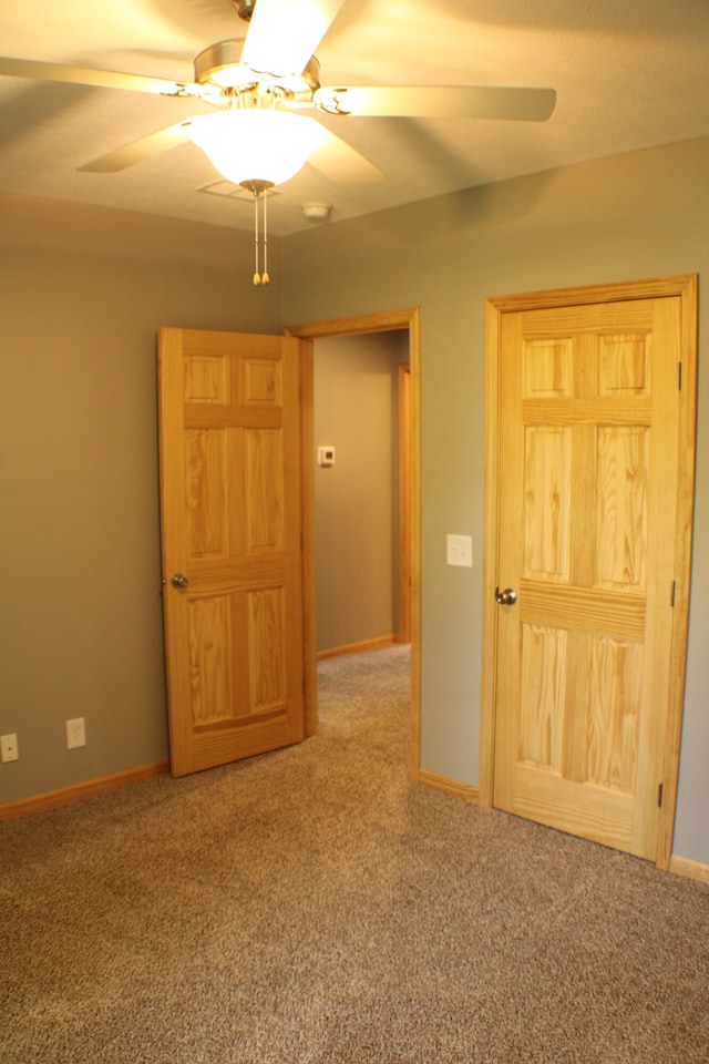 unfurnished bedroom with ceiling fan and carpet flooring