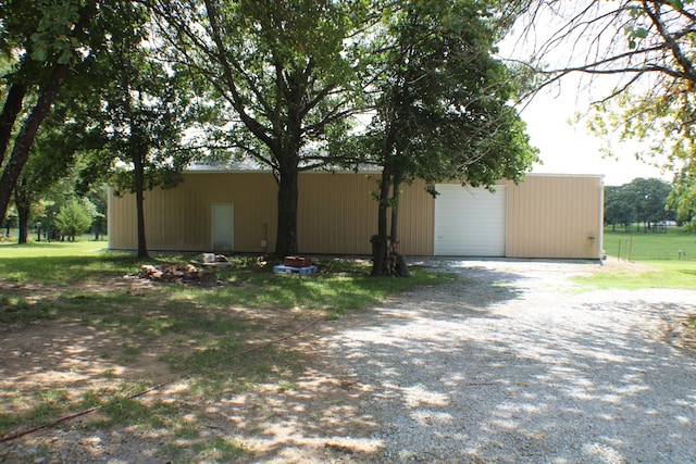 view of property exterior with an outbuilding and a garage