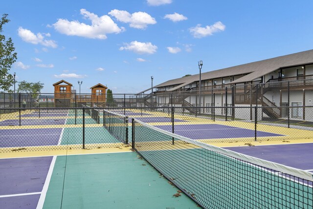 view of sport court featuring fence