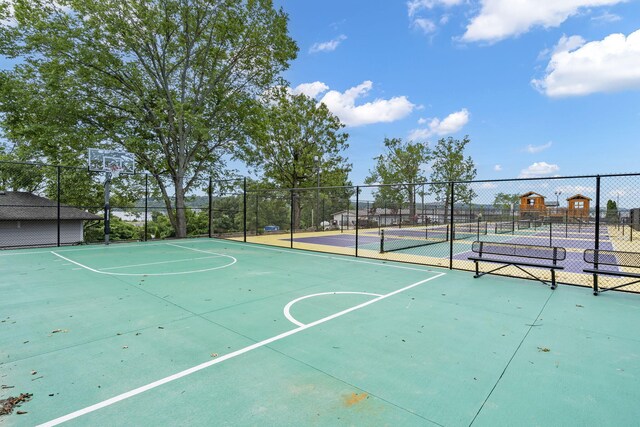 view of basketball court featuring community basketball court and fence