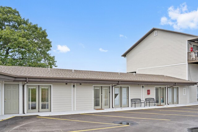 view of building exterior with uncovered parking