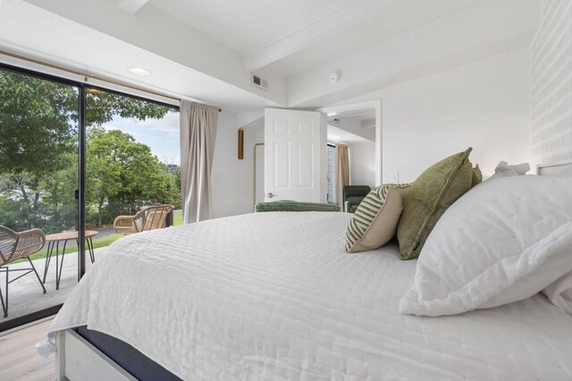 bedroom with visible vents, beamed ceiling, recessed lighting, wood finished floors, and access to outside