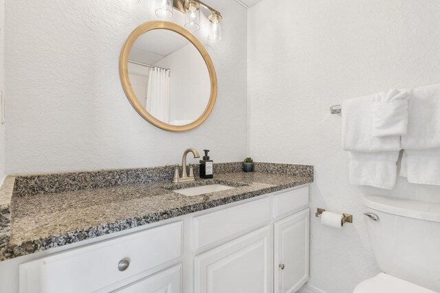 full bathroom featuring toilet and vanity