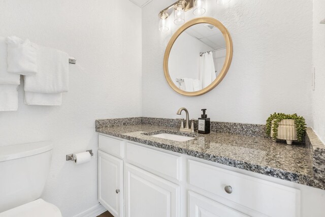 full bath featuring toilet and vanity