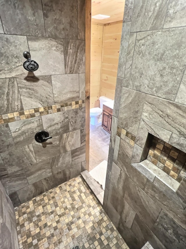 bathroom featuring a fireplace and a tile shower