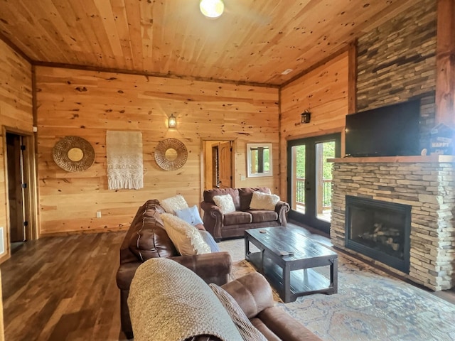 living room with hardwood / wood-style flooring, a fireplace, wood walls, and wooden ceiling