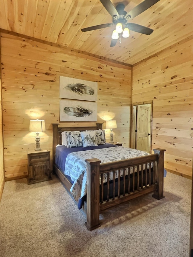 bedroom featuring ceiling fan, wooden walls, wood ceiling, and carpet