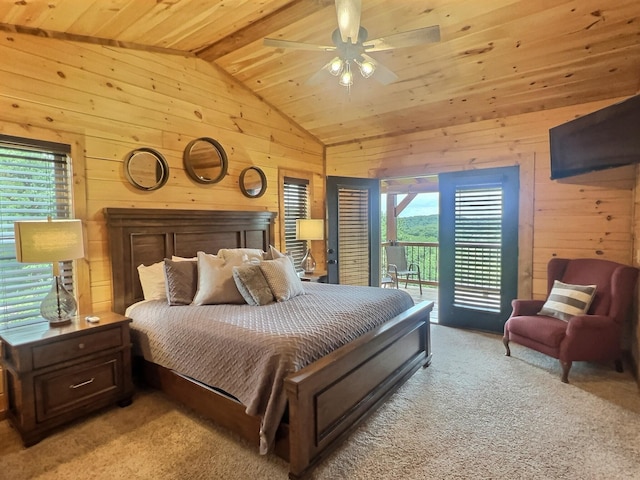 bedroom featuring light carpet, wooden walls, and multiple windows