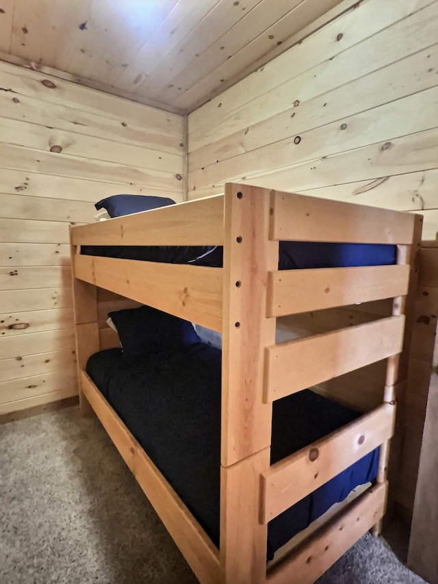 bedroom with wood walls and wood ceiling