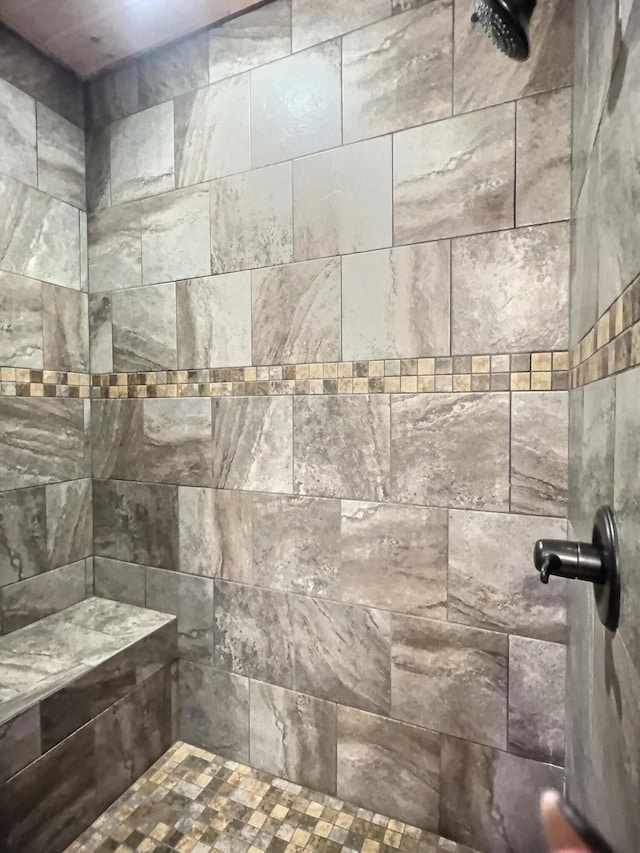 interior details featuring a tile shower