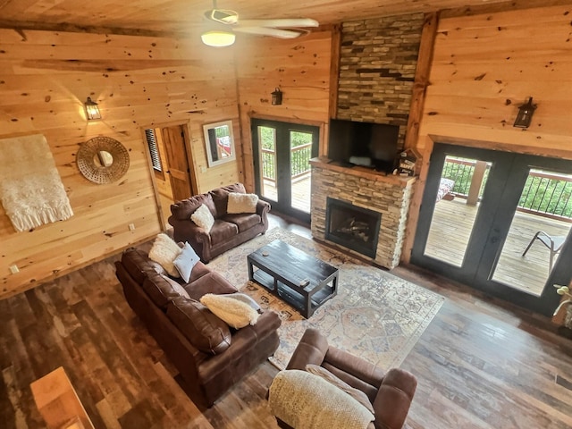 living room with wood-type flooring, high vaulted ceiling, wooden walls, and wood ceiling